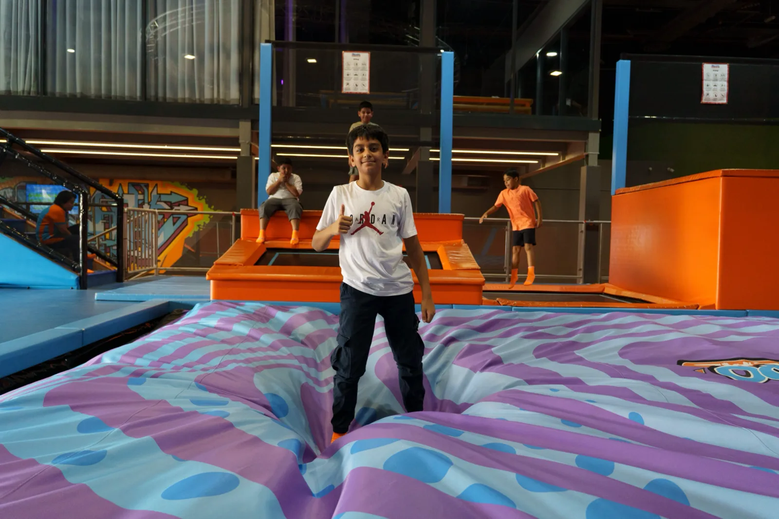 Boy giving a thumbs up after a clean BigAirBag landing