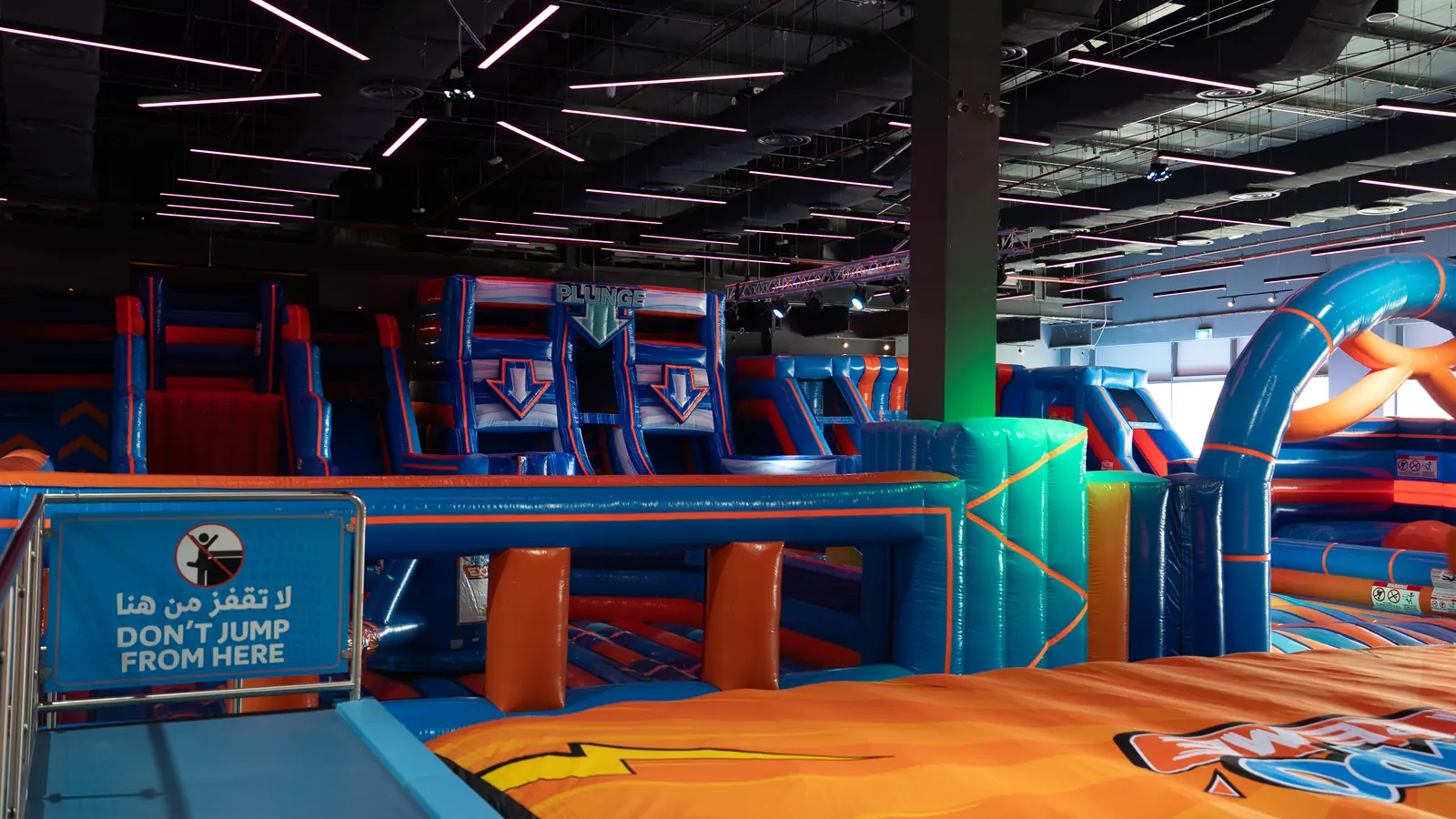 Inflatable slides and climbing towers next to the trampoline court at Trampo Murouj
