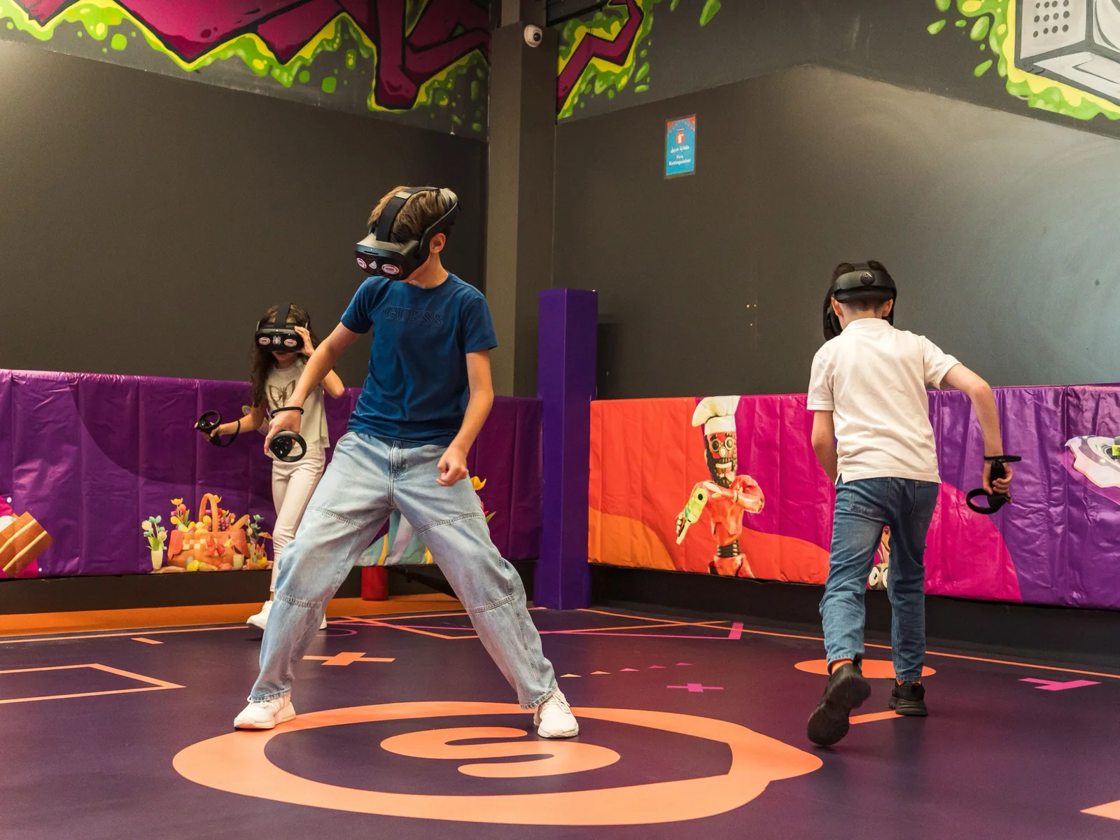 Kids battling enemies inside the multiplayer free-roam VR experience at The Game Corner