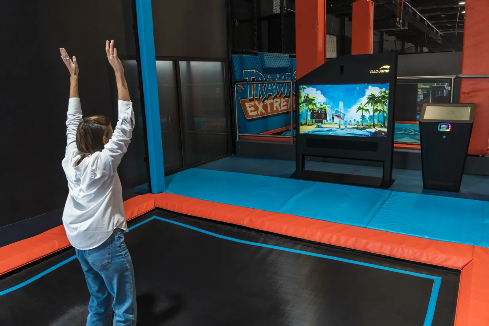 Player throwing her arms up after scoring on the Valo Jump basketball game
