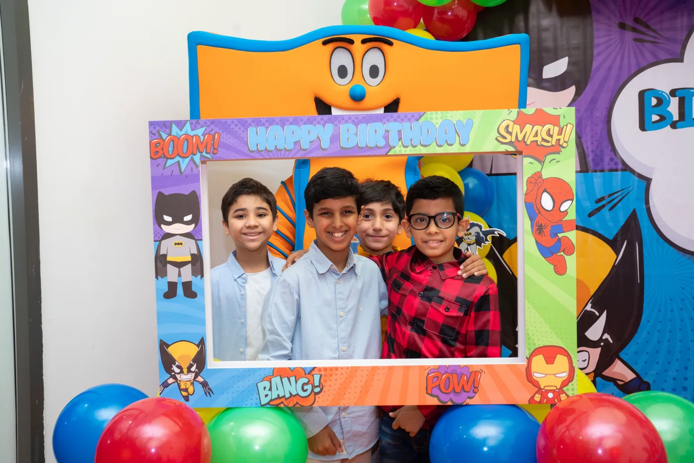 Friends posing in a comic-style birthday photo frame